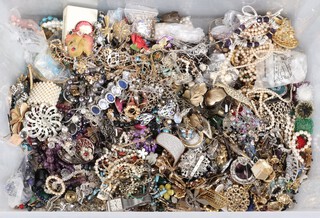 A large collection of costume jewellery including beads, necklaces, simulated pearls, brooches, bracelets, wristwatches, etc, all contained in a plastic box 