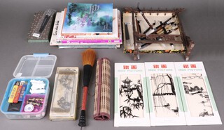 A Chinese calligraphy/artists set and a collection of pierced metal panel decorations 