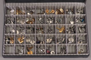 A large collection of pairs of base metal and enamel cufflinks, contained in a plush box 