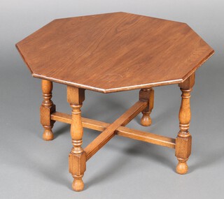 An oak octagonal occasional table raised on turned supports with X framed stretcher 40cm h x 61cm w x 61cm d 