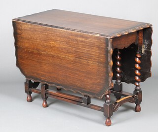 A 1930's rectangular oak drop flap gateleg dining table with pie crust edge 73cm h x 104cm w x 50cm d 