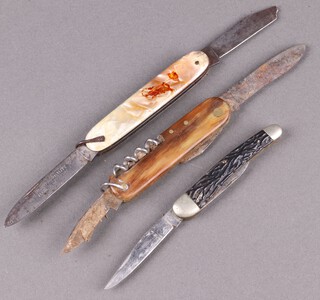 A multi bladed pocket knife with horn grip, a "The Skinner" folding pocket knife with simulated mother of pearl grip (1 blade a/f) and a twin bladed folding pocket knife marked CK  