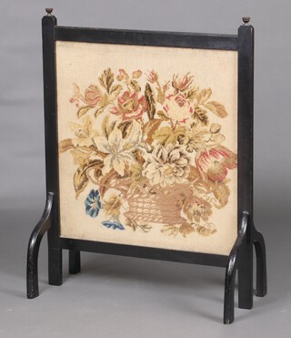 A Victorian ebonised fire screen with Berlin wool work panel to the centre 94cm h x 72cm w x 36cm d 