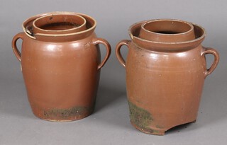A pair of pottery twin handled garden urns 43cm (1 chipped, 1 with hole to base) 