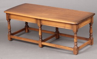 An Ercol elm rounded rectangular coffee table (scratch to top and contact marks in places) 41cm h x 114cm w x 49cm d 