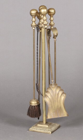 A brass 4 piece fireside companion set