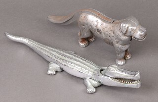 A metal nut cracker in the form of a crocodile nut cracker and a Labrador nut cracker