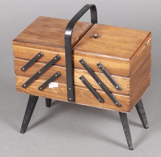 A 1960's beech cantilever sewing box, raised on ebonised supports 43cm h x 42cm w x 20cm d (leg a/f) 