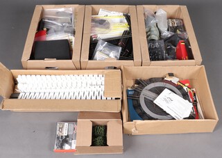 A collection of Model Railway OO gauge to include a large quantity of Hornby Nickel-Silver track, point motors, line side accessories, buildings and scenery items. Track includes 40 R601 double straights, shorter straights and various curves, 20 points in their original cartons, 10 boxed and unused Hornby R8014 point motors and a further 12 unboxed. A motorised turntable.  Hornby station and accessories including figures, animals, tunnels, buffers and bridge supports, scenery items of 4 trees, bagged ballast and coal, additional building kits and various (used) Woodland Scenic inclines
