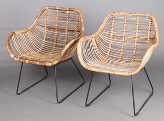 A pair of bamboo and metal framed armchairs 