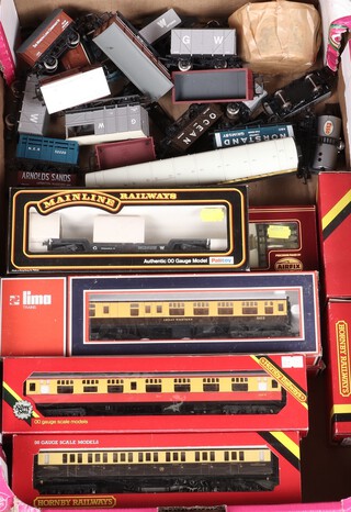 Six Hornby OO gauge carriages boxed, 2 Lima carriages boxed, a quantity of other carriages and rolling stock, contained in a fruit box