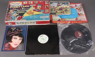 A Chad Valle "Give a Show Projector", 2 jigsaw puzzles and a small collection of records 