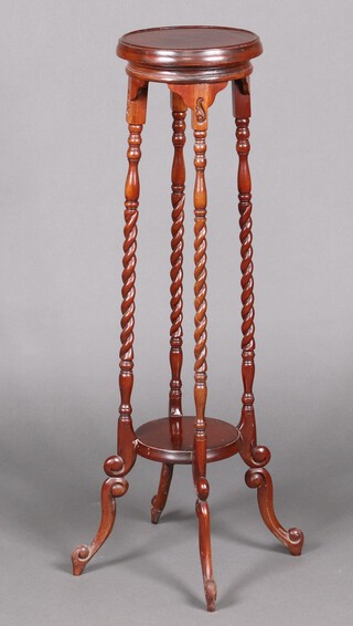 A Victorian style circular mahogany 2 tier jardiniere stand, raised on turned supports 103cm h x 26cm diam. 