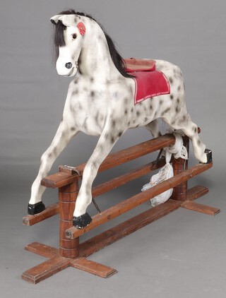 A dapple grey rocking horse, raised on a pine cruciform frame 147cm h x 165cm w x 54cm d 
