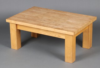 A rectangular oak coffee table raised on square supports 39cm h x 90cm w x 60cm d (sun bleached) 