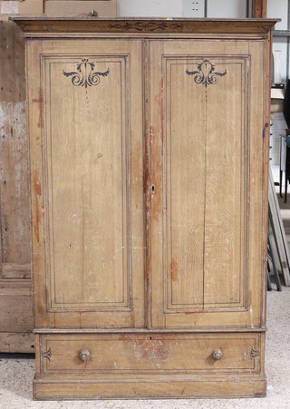 A Victorian painted pine wardrobe with moulded cornice, enclosed by panelled doors, the base fitted a drawer 198cm h x 133cm w 44cm d (split to both door panels) 