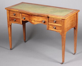 An Edwardian inlaid mahogany bow front writing table with inset green leather writing surface, above 1 long and 4 short drawers, raised on square tapered supports with brass caps and casters 73cm h x 107cm w 50cm d  