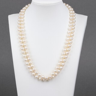 A double strand of cultured pearls with gold marked 9ct garnet and pearl floral clasp 47cm 