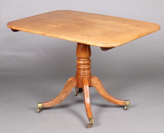 A Regency rectangular bleached mahogany breakfast table, raised on a turned column and tripod base with brass caps and casters 72cm h x 107cm w x 75cm d 