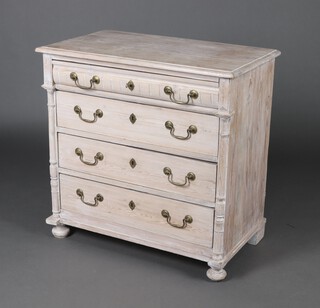 A 19th Century Continental limed pine chest of 4 drawers with brass swan neck drop handles and turned columns to the side, raised on bun feet 87cm h x  87cm w x 49cm 