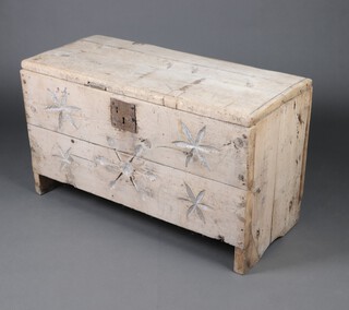 A 17th/18th Century continental carved pine coffer of panelled construction with hinged lid, the front carved stylised stars and with faux iron lock 64cm h x 110cm w x 46cm d  