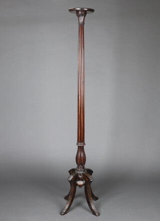 A William IV turned and reeded mahogany bed post torchere, raised on a tripod base 193cm high x 22cm diam. 