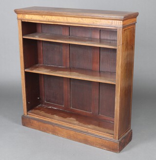 An Edwardian inlaid mahogany open bookcase fitted adjustable shelves, the top inlaid an oval medallion and with swag and floral decorations, raised on a platform base 114cm h x  105cm w x 29cm d 