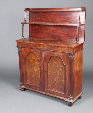 A Regency mahogany chiffonier with 2 raised shelves to the back above a secret drawer with cupboard enclosed by arched panelled doors, raised bun feet 143cm h x 107cm w x 38cm d 