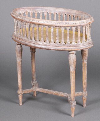 An 18th Century style oval pierced limed wood planter, raised on turned and fluted supports with H framed stretcher 76cm h x 69cm w x 40cm d 