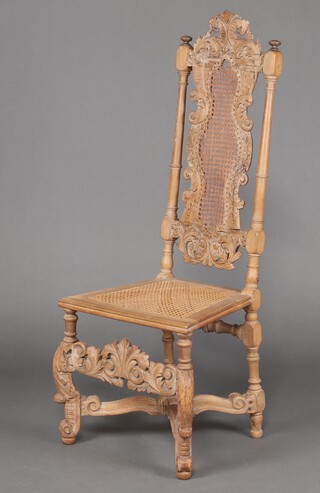 A 17th/18th Century continental carved pine and beech high back chair with arched carved cresting rail, woven cane panel to the centre, raised on cabriole supports with X framed stretcher 