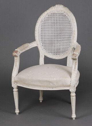 A 19th/20th century  French white painted wooden open arm salon chair with over stuffed seat, raised on turned and fluted supports  