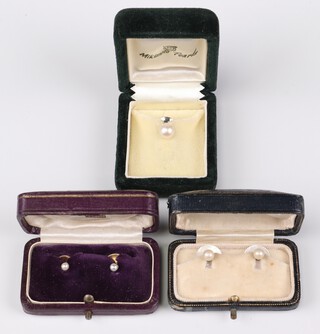 An 18ct gold and pearl dress stud, a 15ct ditto, a pair of mother of pearl dress studs and a pearl tie tack, all cased