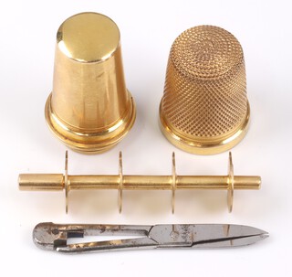 A Cartier 9ct gold necessaire sewing etui set, comprising a gold spool for 4 threads, pair of scissors and  needle, all contained in a 9ct gold case, the top being a thimble and complete with original fitted Cartier case, 5cm l, gross weight 26g   