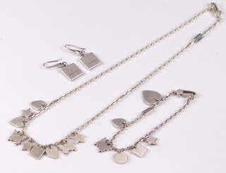 A suite of Gucci 925 silver jewellery comprising necklace hung charms 43cm, bracelet 18cm and a pair of earrings marked Gucci, 35g gross, in original boxes 