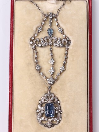 A Georgian white metal foiled back blue and white paste set ornate pendant, hung on a fine link integral chain, with original fitted box