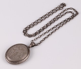 An oval engraved silver locket hung on a belcher link chain, 32g gross