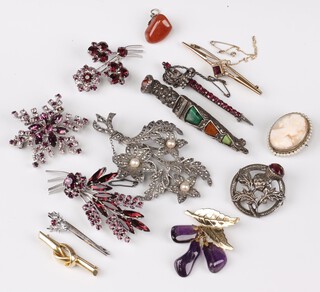 A shell carved cameo brooch, a hardstone brooch in the form of a dirk, a floral marcasite brooch and other brooches 