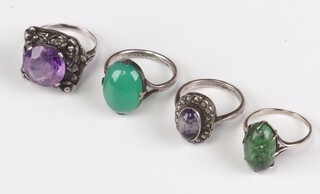 A silver and cabochon cut hardstone ring and 3 other rings 