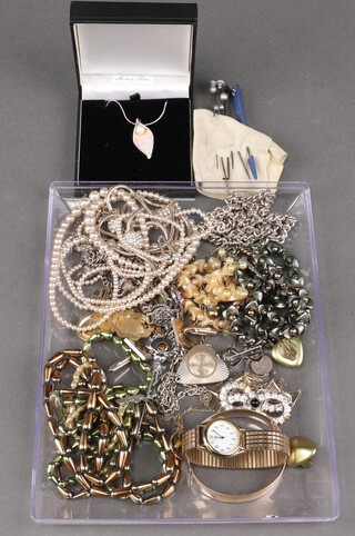 A Sterling silver pendant in the form of a leaf seat a pearl hung on a fine silver chain and other items of costume jewellery 