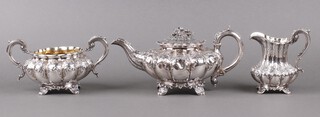 A William IV embossed silver 3 piece tea service of melon form comprising teapot, sugar bowl and milk jug, with phoenix armorial, London 1835 by Joseph Angell I and John Angell I, 1343g gross Ivory Exemption Certificate J789XVXB