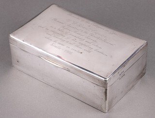 A silver cigar/cigarette box London 1913 by Sampson Morden & Co., the lid engraved "Presented by his colleagues in office to W F Stowel Esq ....1916" 8cm x 23cm x 14cm 