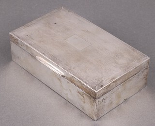 An Art Deco rectangular silver cigarette box with hinged lid and engine turned decoration 4cm x 15cm x 9cm, marks rubbed 