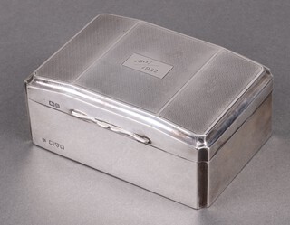 An Art Deco rectangular silver cigarette box with hinged lid and engine turned decoration, lid engraved, Chester 1929 by James Deakin & Sons 6cm h x 12cm w x 9cm d 