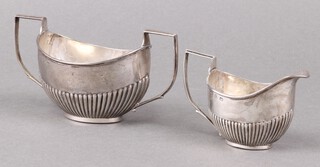 A Victorian oval silver sugar bowl and matching cream jug with demi-reeded decoration, Birmingham 1898 by Henry Bourne, 109g 