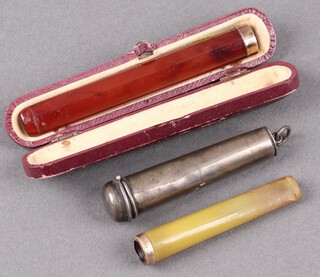 A silver cheroot holder case, Chester 1924 (some dents), containing a cheroot holder marked 9ct gold, an amber "cheroot" holder with 9ct gold mount 