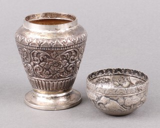 A circular embossed metal bowl 6cm together with an embossed metal vase 9cm 