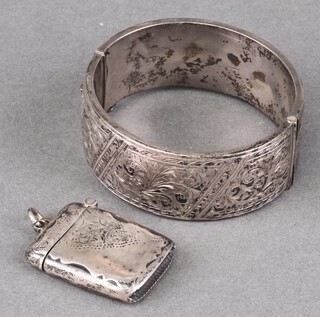 A hollow engraved silver bangle together with a vesta case (some dents), 53g 