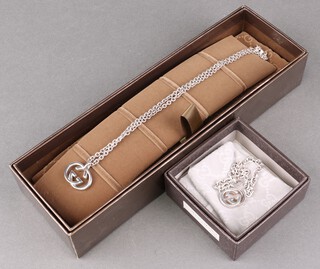 A suite of Gucci 925 silver jewellery comprising belcher link bracelet and necklace, both with pendants, 47g gross, in original boxes 
