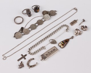 A silver Silver Jubilee ingot pendant, a silver horse shoe charm, a miniature silver ingot pendant, a silver curb link bracelet with padlock clasp, a silver bracelet formed from sixpences and a small collection of costume jewellery 