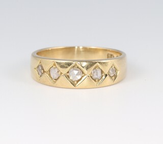 An 18ct gold wedding band set 5 diamonds, size L 1/2, 4.4g 